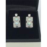 A pair of silver CZ and opal panelled art deco style earrings