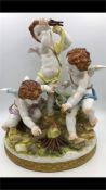 A china figurine of three cherubs by Algora