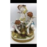 A china figurine of three cherubs by Algora