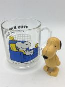 A Vintage Snoopy glass mug and wind up toy