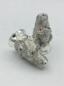 A pair of unusual continental silver condiments in the form of digs with ruby eyes