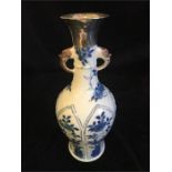 A Kangxi period Chinese blue and white vase with silver top.