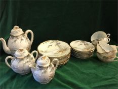 A Japanese six setting tea set to include teapot, sugar bowl, milk jug saucers, cups, side plates.