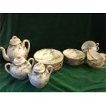 A Japanese six setting tea set to include teapot, sugar bowl, milk jug saucers, cups, side plates.