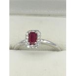 An 18ct white gold ruby and diamond cluster ring of 50 points approx