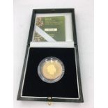 A gold proof 22ct £2 coin celebrating the discovery of DNA