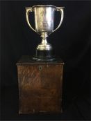 A Hallmarked silver trophy on ebonised stand and in wooden presentation box