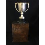 A Hallmarked silver trophy on ebonised stand and in wooden presentation box