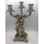 A 19th Century three prong candlestick with cherubs