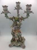 A 19th Century three prong candlestick with cherubs