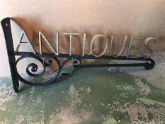 A wrought Iron Antiques Shop sign