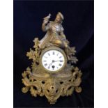 A small gilt clock, with a young child holding a bird.