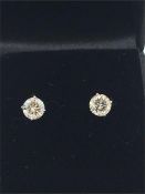 A pair of 14ct white gold diamond stud earrings of 1ct.