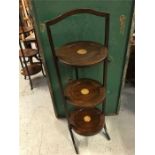 A wooden cake stand with center shell style decoration