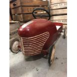 A Vintage French Childs push car in red.