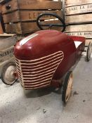 A Vintage French Childs push car in red.