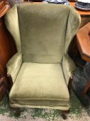 A Green wing back chair