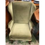 A Green wing back chair