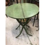 A collapsible wooden table in green.