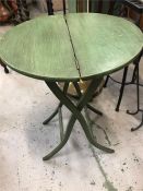 A collapsible wooden table in green.