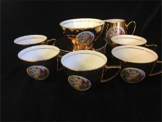 A set of five Czechoslovakian gold tea cups and saucers, milk jug and sugar bowl
