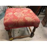 A red fabric covered stool