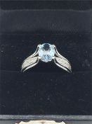 A 14ct white gold Aquamarine and diamond halo style ring