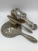 Silver backed ladies vanity brushes and a mirror