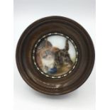 A painting on tile of a kitten in the Bessie Bamber style set to an easle back frame