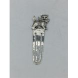 A silver bookmark with kitten finial