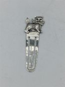 A silver bookmark with kitten finial