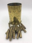 A shell and some spent brass bullets.