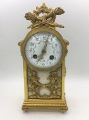 A French Eight Day Mantle clock with enamel face with flora decoration