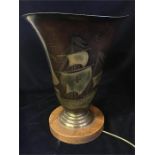 A Metal uplighter lamp with Crusade ship style decoration