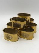 Set of eight gold coloured napkin rings