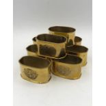 Set of eight gold coloured napkin rings