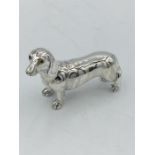 A heavy cast silver figure of a dog