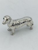 A heavy cast silver figure of a dog