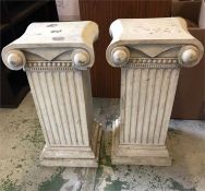 A pair of pillar style pedestals