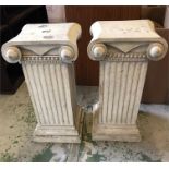 A pair of pillar style pedestals