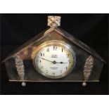 A white metal mantle clock by Connell of Cheapside London