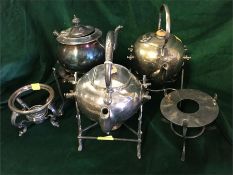 A selection of three plated teapots and five stands.