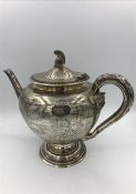 A silver teapot with helmet finial, hallmarked to base Edinburgh 1876, makers mark JA