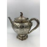 A silver teapot with helmet finial, hallmarked to base Edinburgh 1876, makers mark JA