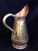 A Copper and brass jug in an Arts and Crafts style.