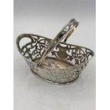 A silver hallmarked basket with handle, makers mark M + C.