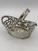 A silver hallmarked basket with handle, makers mark M + C.