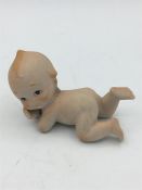 A porcelain figure of a Baby