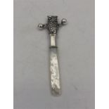 A silver owl shaped Babies rattle with mother of pearl handle