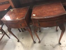 A pair of bedside tables with glass tops.